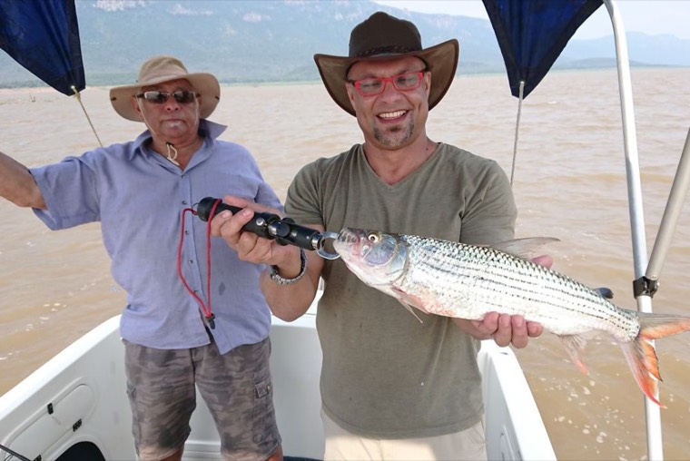 Two anglers holding a tiger fish caught on Lake Jozini